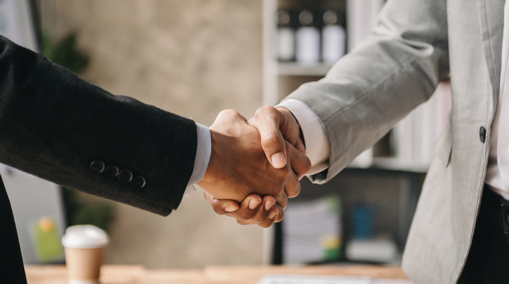 Business professionals shake hands, symbolizing trust and collaboration