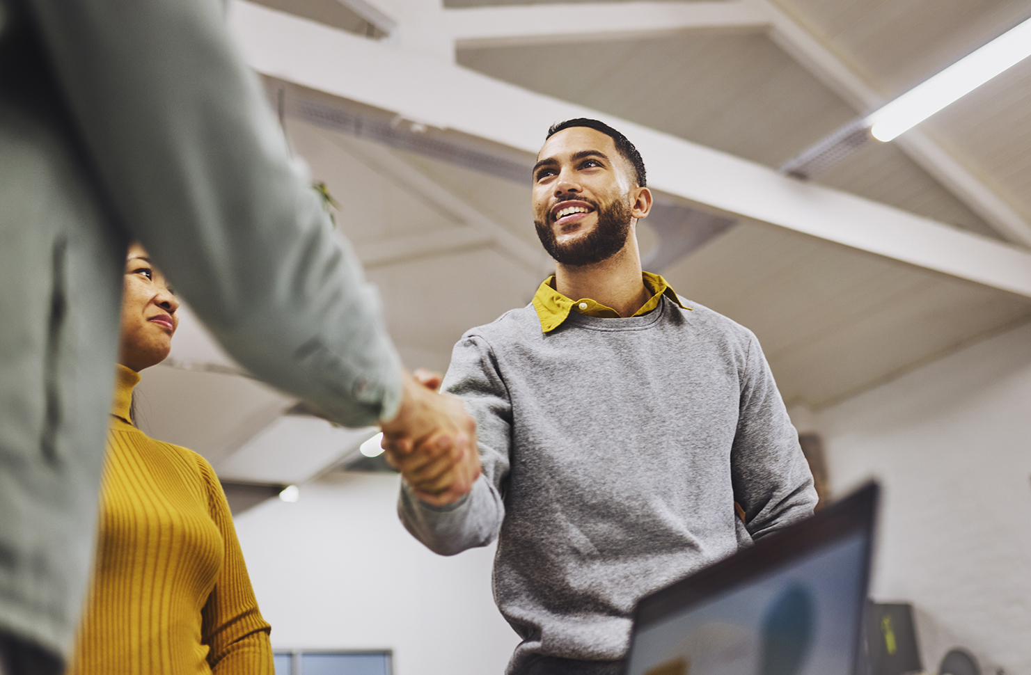 An agent shakes hands with his smiling client